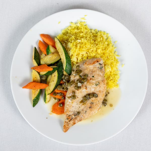 Lighthouse Bistro's chicken piccata with capers, yellow rice, and sautéed zucchini and carrots.