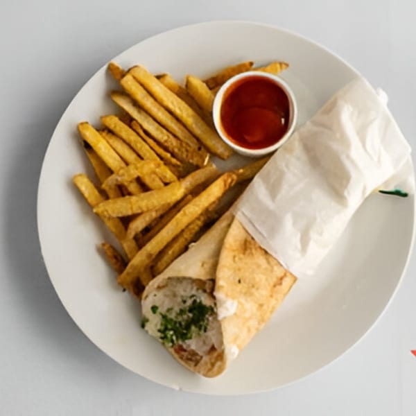 Lighthouse Bistro's chicken shawarma wrap with fries and ketchup on a white plate.