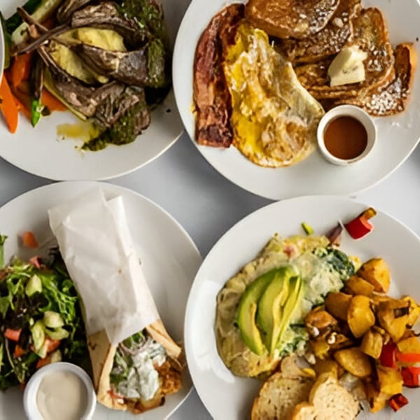 Four plates of diverse bistro dishes, including breakfast, a wrap, and roasted vegetables.